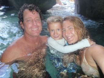 Former Emler swim instructor Sophia McKenzie with her husband and daughter swimming in the ocean