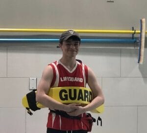 Male lifeguard with yellow rescue float
