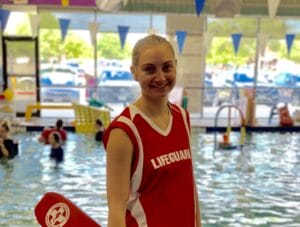 Emler lifeguard Makenzie in front of the Round Rock school's indoor pool